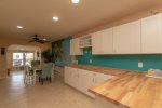 Spacious kitchen counter with wine rack and breakfast bar